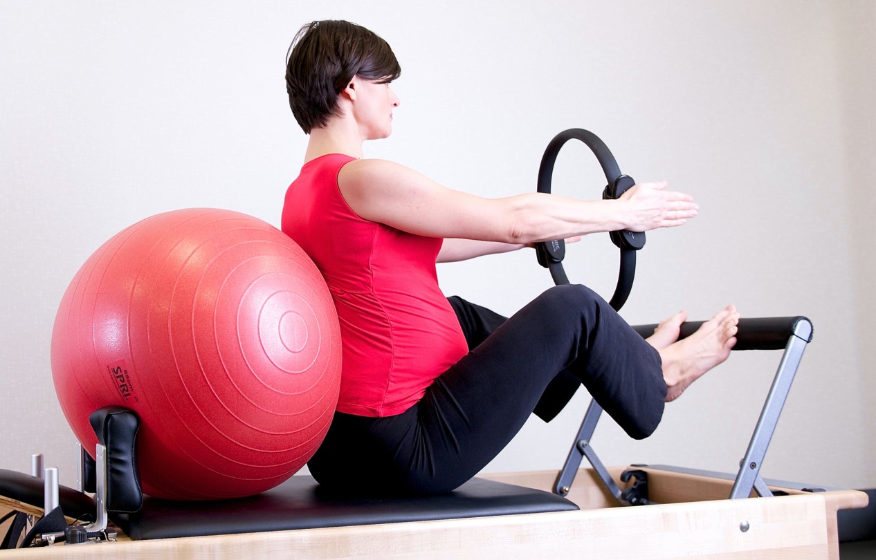 a women is using reformer pilates at home